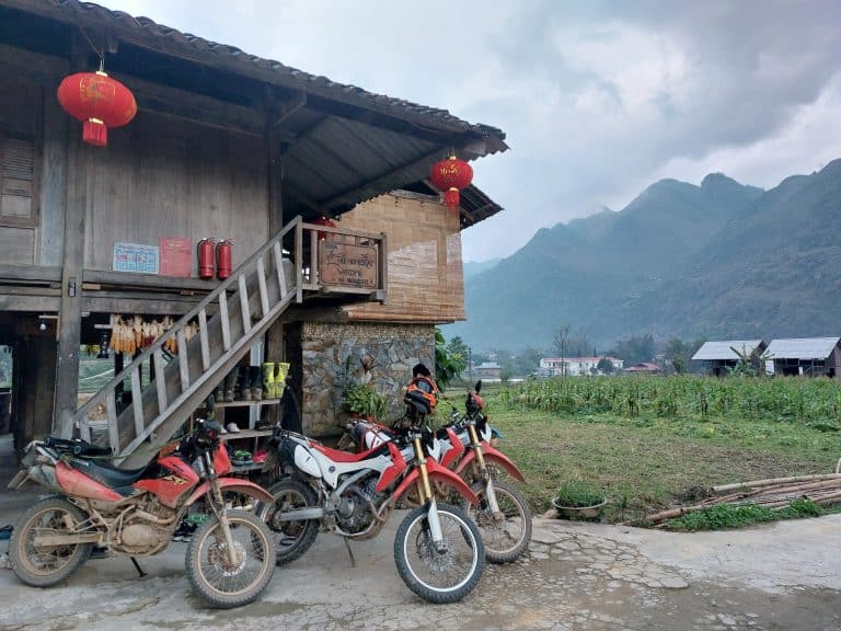 Motorbikes parked up at a small family homestay in Du Gia, Ha Giang