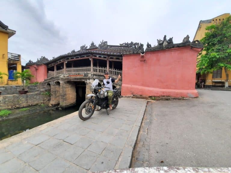 Our Tour Leader on his Royal Enfield Himalayan at the japanese bridge in Hoi An