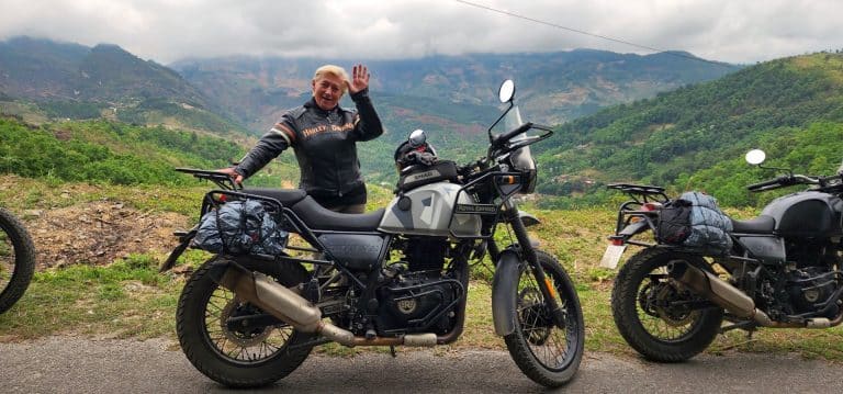A happy rider and his Royal Enfield in the vietnamese mountains