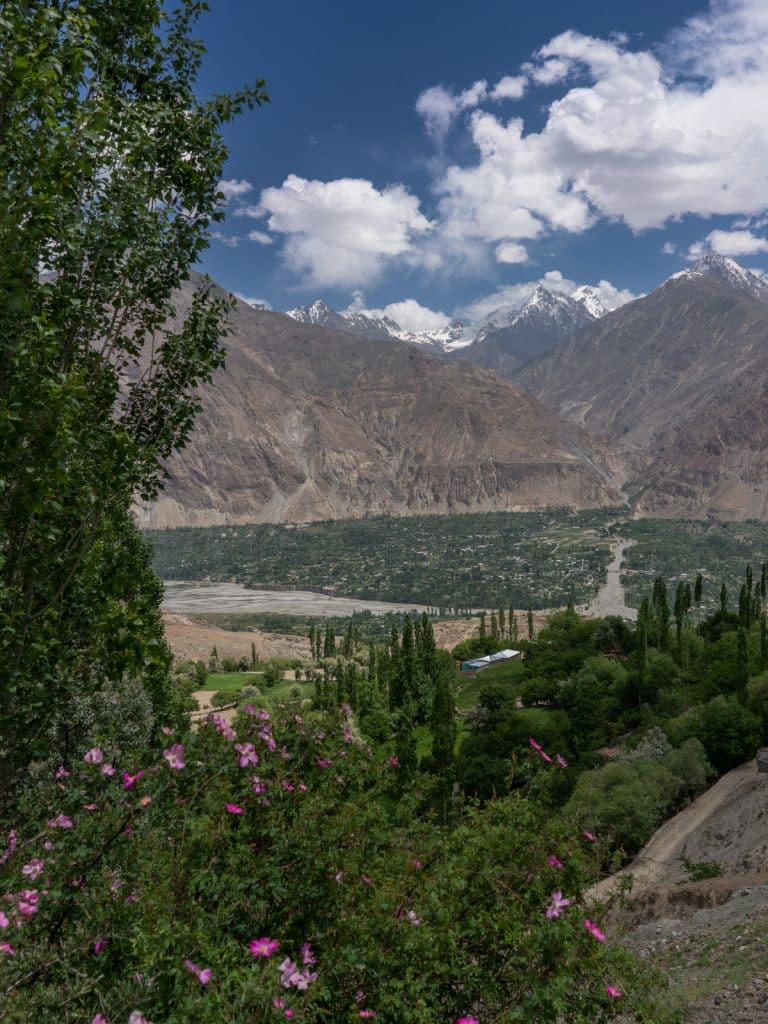 beautiful green valley and snow topped mountains in Pakistan seen from motorbike tour