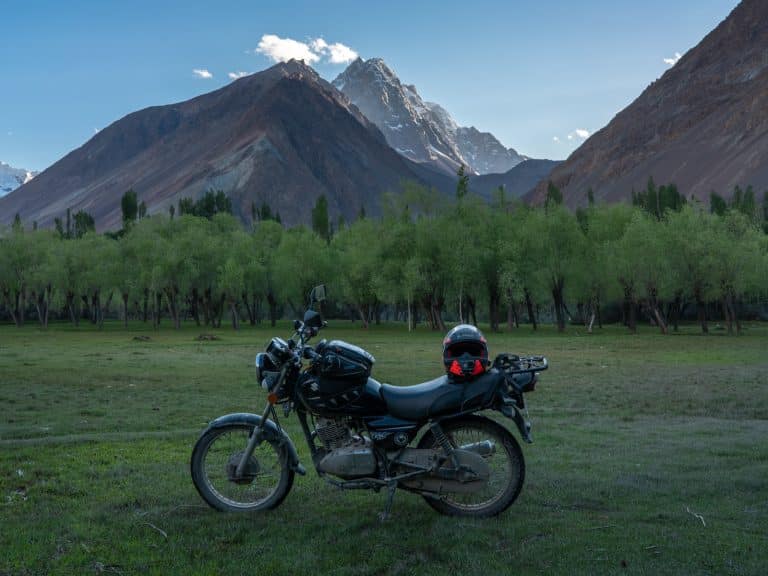 motorbike parked in front of beautiful Pakistan landscape on motorbike tour through the mountains