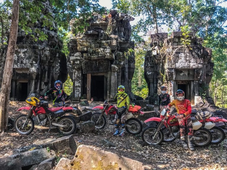 riders stopped in front of hidden temples in the middle of the Cambodian jungle