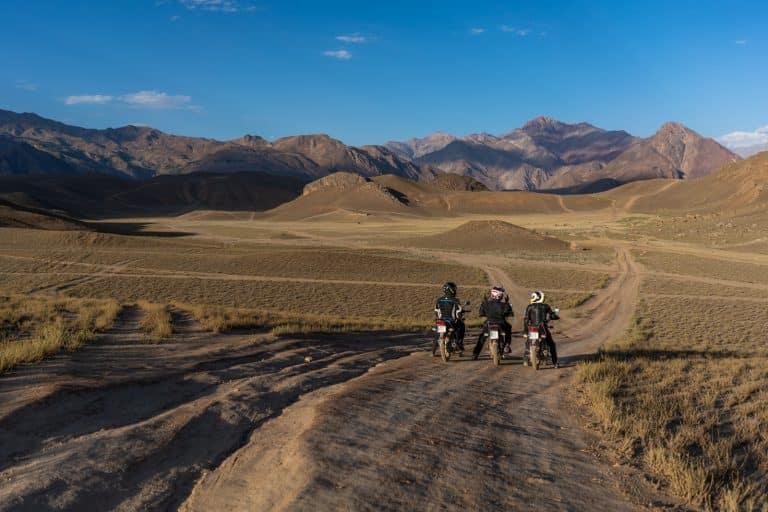 three ADV Outriders view the long ride ahead while on motorbike tour in Pakistan