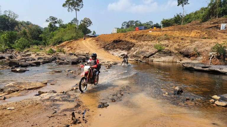 two ADV Outriders cross river in Cambodia