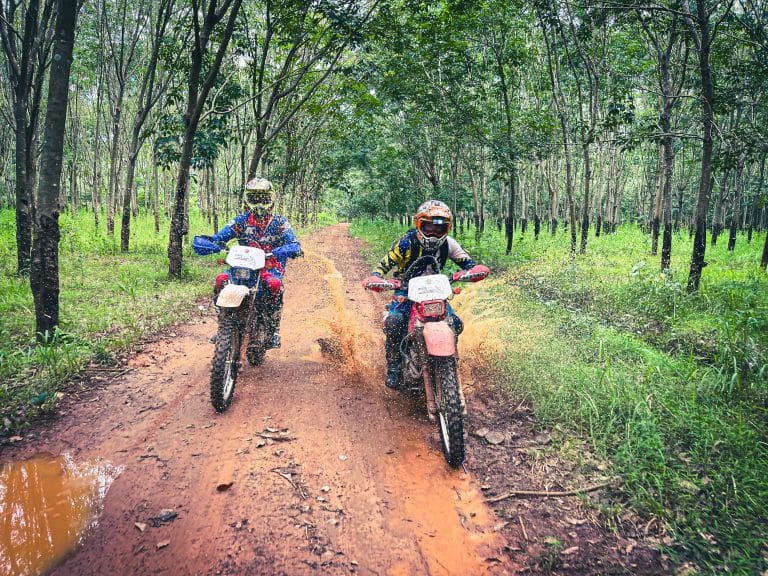 two ADV Outriders ride through mud on motorbike tour in Cambodia